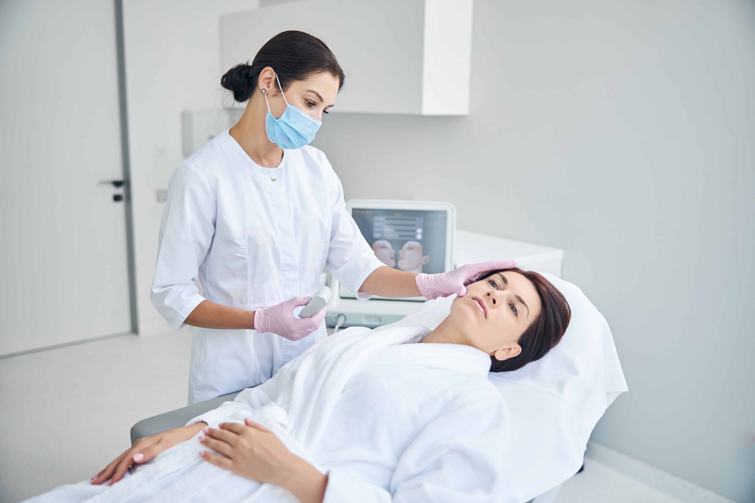 Dermatologist examining patient's skin